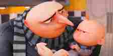 Gru holding his son Gru Jr., who glares at him, in Despicable Me 4