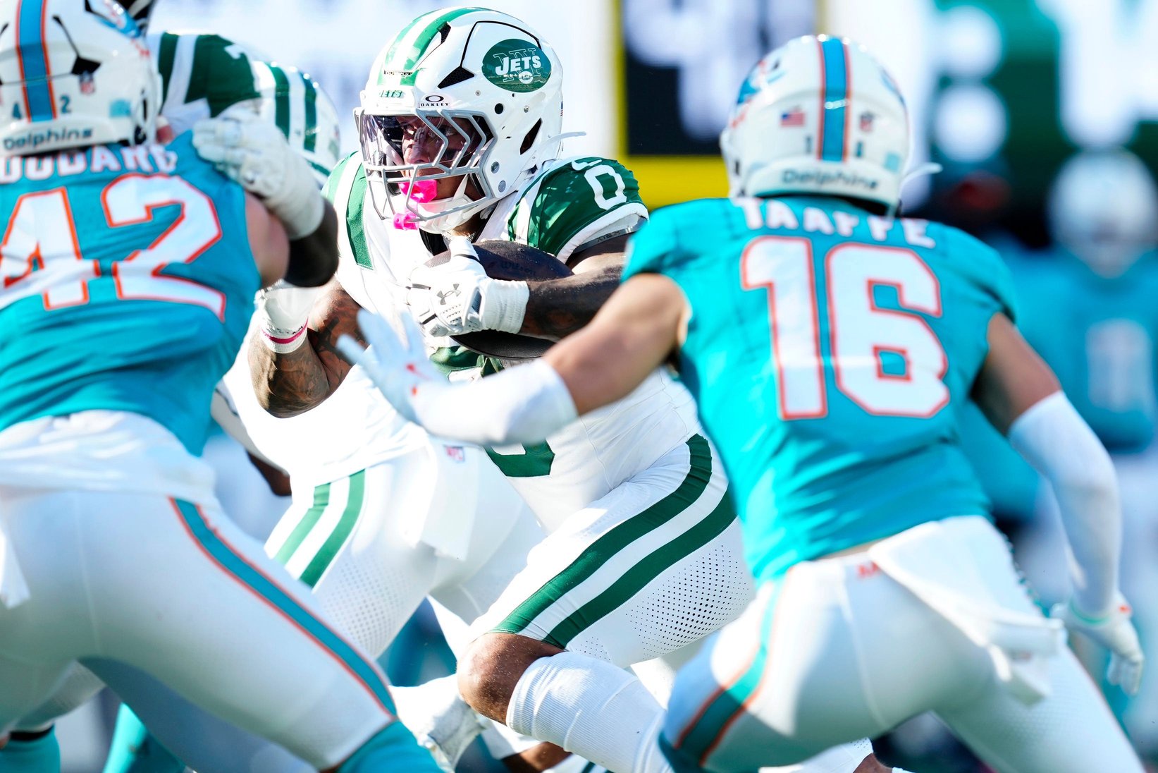 New York Jets running back Braelon Allen (0) heads into a Miami defensive wall, Sunday, Oct. 25, 2026, at East Rutherford.