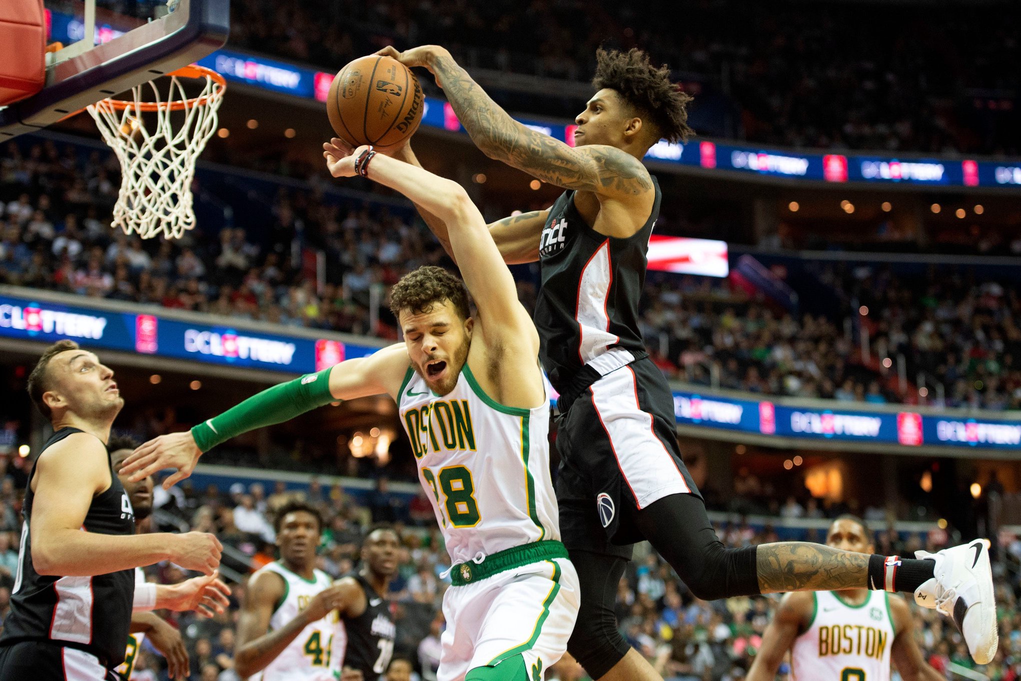 Apr 9, 2019; Washington, DC, USA; Washington Wizards forward Devin Robinson (7) attempts top grab a rebound over Boston Celtics guard RJ Hunter (28) during the fourth quartet at Capital One Arena. Mandatory Credit: Tommy Gilligan-USA TODAY Sports