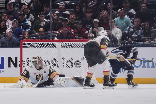 Vegas Golden Knights goaltender Carter Hart (79) watches as the puck enters the goal on a shot from Columbus Blue Jackets defenseman Denton Mateychuk, right, during the first period of an NHL hockey game Saturday, Oct. 24, 2026, in Columbus, Ohio. (AP Photo/Joshua A. Bickel)