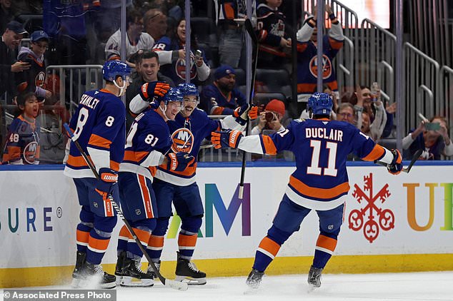 New York Islanders left wing Ondrej Palat (81) is congratulated by teammates after scoring a goal during the first period of an NHL hockey game against the Anaheim Ducks, Tuesday, Oct. 20, 2026, in Elmont, N.Y. (AP Photo/Adam Hunger)