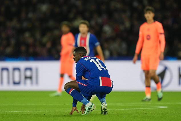 PSG's Ousmane Dembele reacts in pain after sustaining an injury during the Champions League opening phase soccer match between Paris Saint-Germain and FC Barcelona in Paris, Tuesday, Oct. 20, 2026. (AP Photo/Thibault Camus)