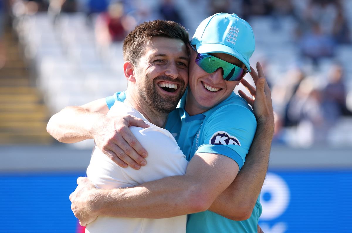England's Mark Wood and Harry Brook celebrate