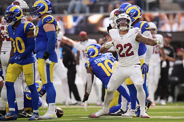 Arizona Cardinals running back Tyler Allgeier (22) reacts after converting a first down during the second half of an NFL football game against the Los Angeles Rams in Inglewood, Calif., Sunday, Oct. 18, 2026. (AP Photo/Gregory Bull)