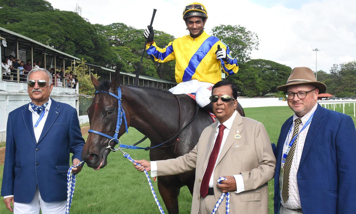 Co-owners S.R. Sanas and K. Kaliyaperumal, along with trainer James Mckeown, leading in Royal Legacy (Akshay Kumar up) after the win in the Mysore Derby on Saturday.
