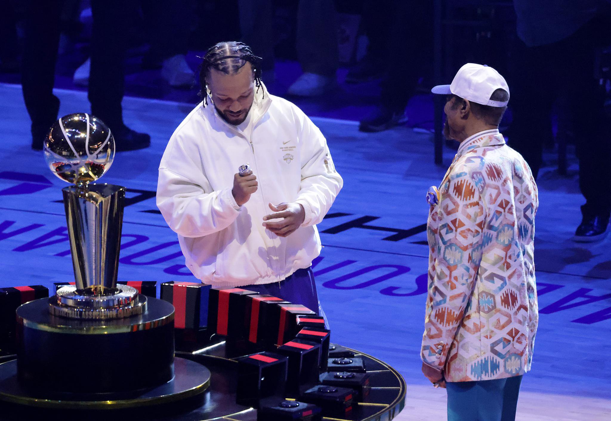 New York Knicks guard Jalen Brunson receives his ring from alumnus Walt "Clyde" Frazier in a ceremony before the opening night game against the Philadelphia 76ers at Madison Square Garden.