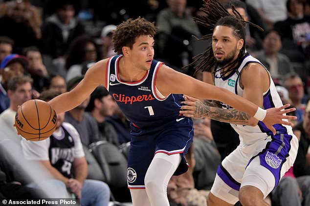 Los Angeles Clippers guard Keaton Wagler (1) is defended by Sacramento Kings guard Emanuel Sharp during an NBA basketball game Wednesday, Oct. 21, 2026, in Los Angeles. (AP Photo/Jayne Kamin-Oncea)