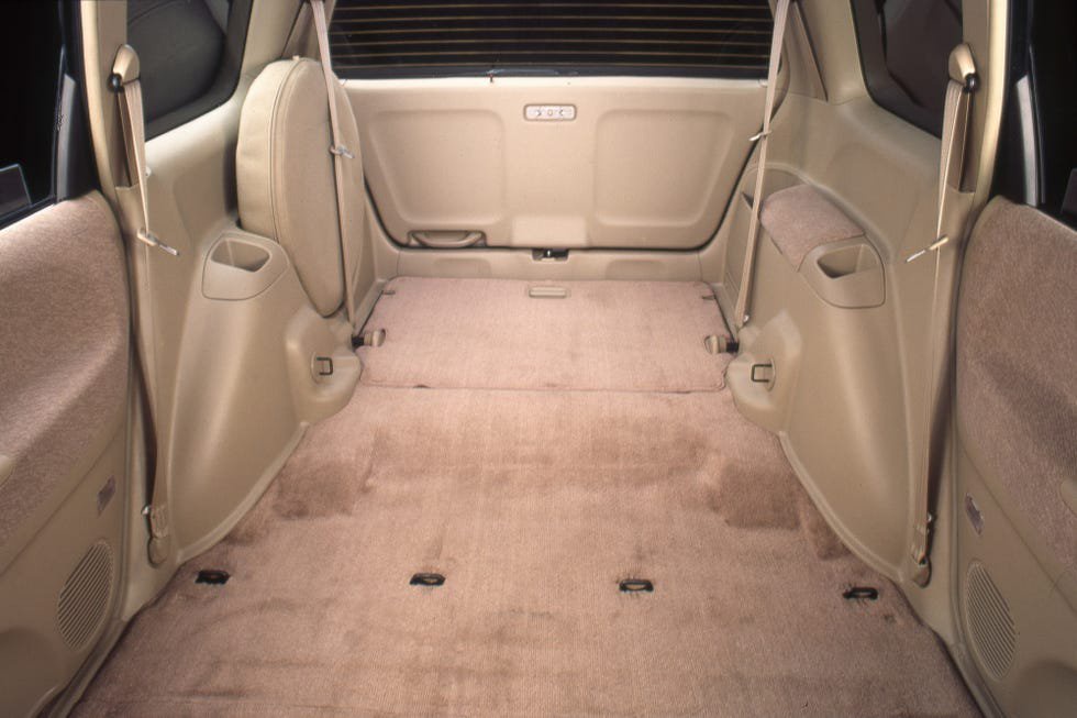 Interior view of a spacious, empty vehicle cargo area with beige upholstery and minimal seating.