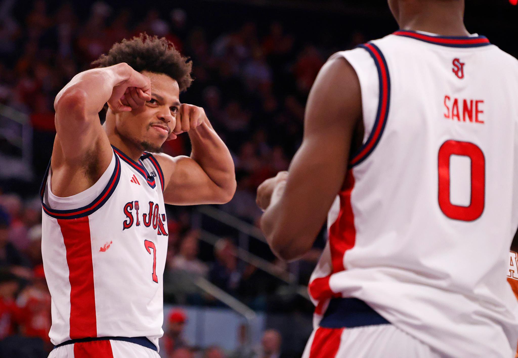 St. John's Red Storm forward Keyshawn Hall flexes toward teammate Babacar Sane after scoring during a game against the Texas Longhorns.