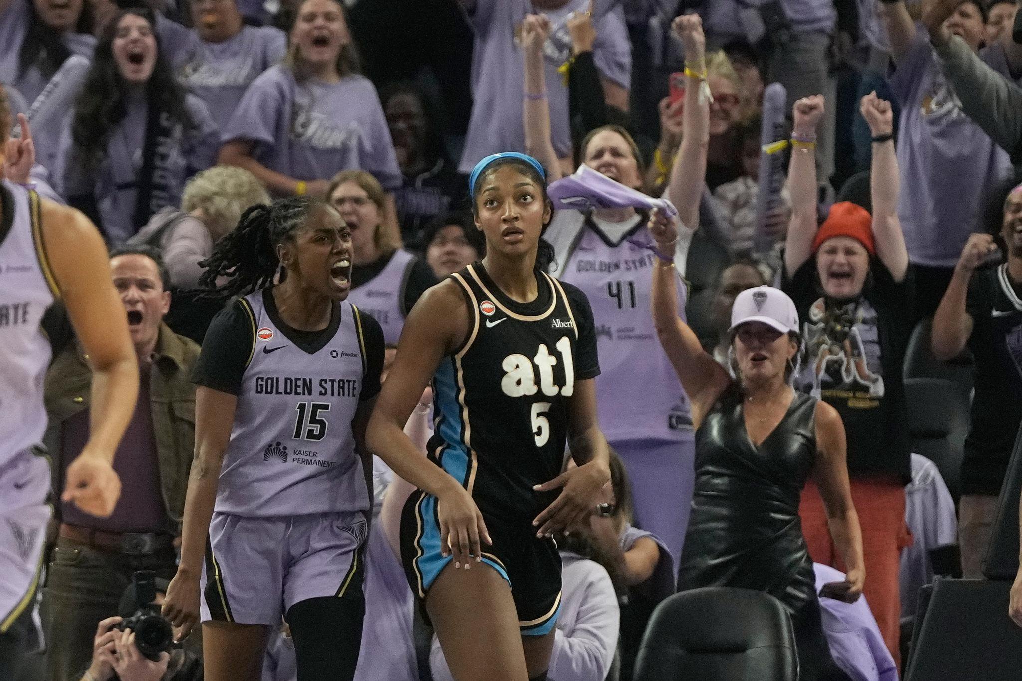 Golden State Valkyries guard Tiffany Hayes (15) celebrates after scoring next to Atlanta Dream forward Angel Reese (5).