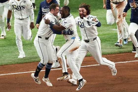 Ben Williamson #15 of the Tampa Bay Rays celebrates with Jorge Mateo #9 and Ryan Vilade #26 after hitting a walk-off single during Game Four of the 2026 World Series presented by Capital One between the Milwaukee Brewers and the Tampa Bay Rays at Tropicana Field on Tuesday.