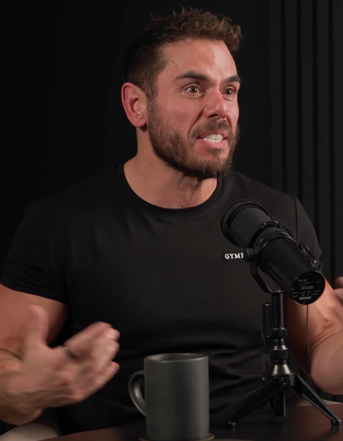Extreme swimmer speaking passionately into a microphone during a podcast interview.