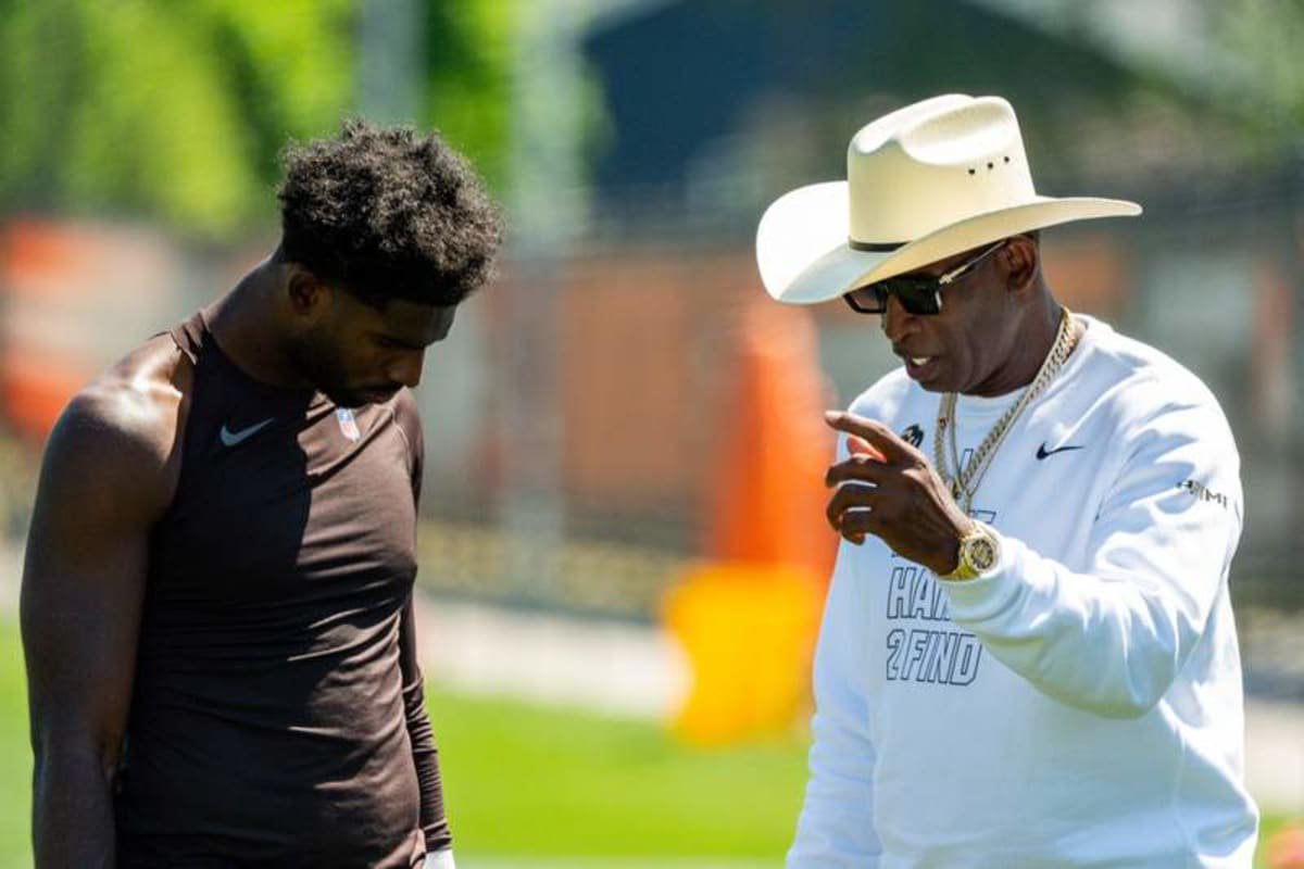 Deion Sanders spends time with his son, Cleveland Browns quarterback Shedeur Sanders (2) at the conclusion of the second day of training camp, July 30, 2026, in Berea, Ohio. ©Andrew Dolph / USA TODAY NETWORK via Imagn Images
