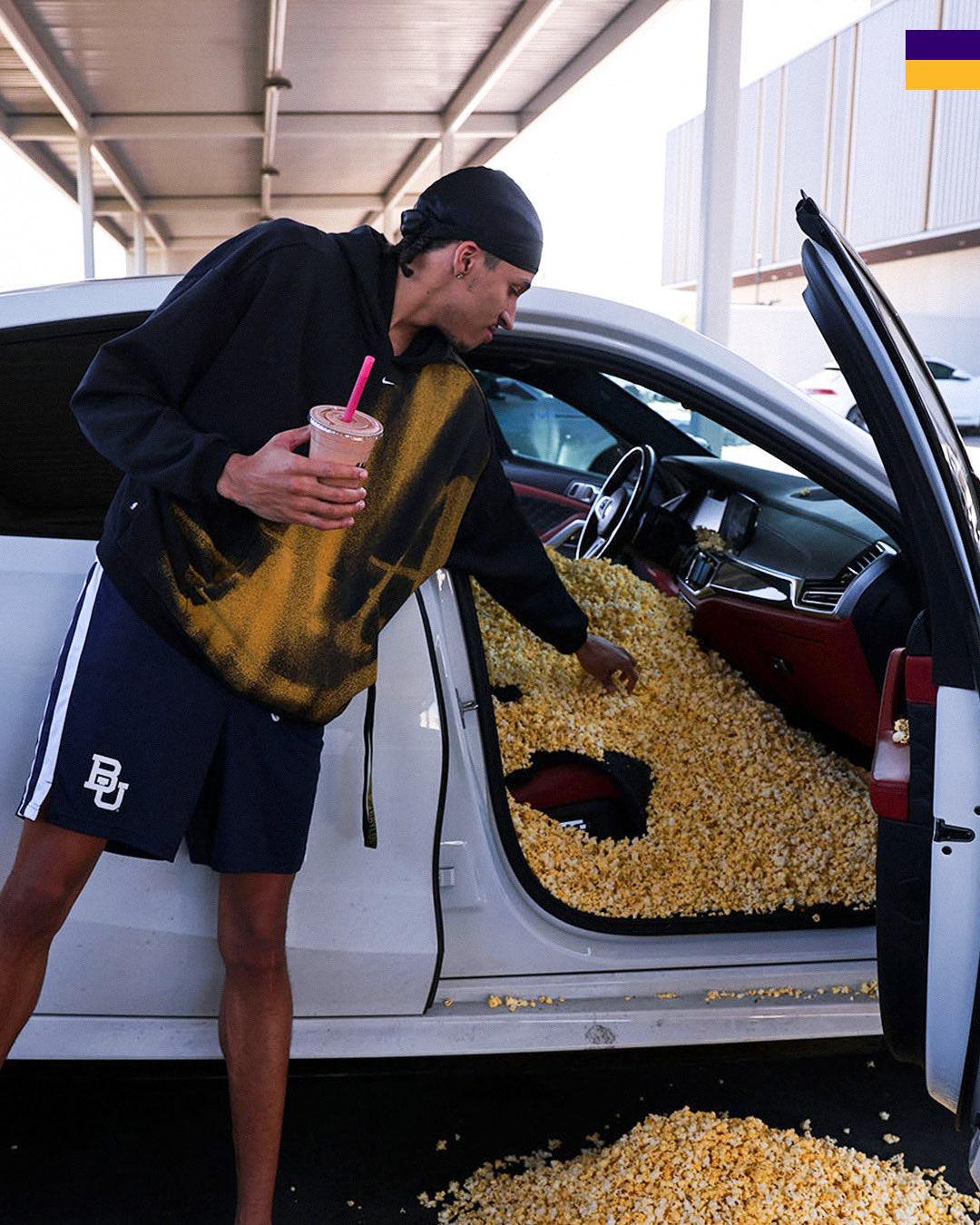 Cameron Carr stands by his car, which is completely filled with popcorn.