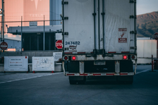 Rear view of a white semi-truck; image by Craig Adderley, via Pexels.com.