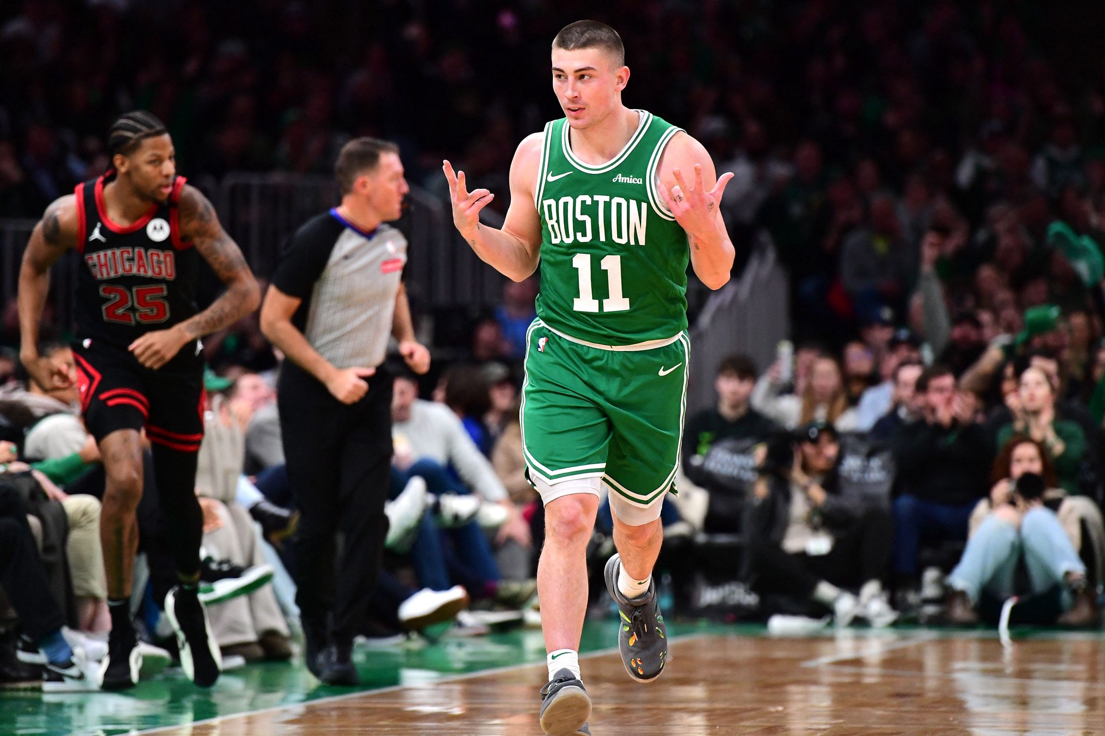 Jan 29, 2025; Boston, Massachusetts, USA; Boston Celtics guard Payton Pritchard (11) reacts after making a three pointer during the second half against the Chicago Bulls at TD Garden. Mandatory Credit: Bob DeChiara-Imagn Images