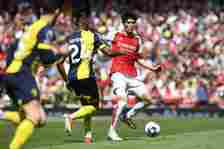 Takehiro Tomiyasu of Arsenal passes the ball whilst under pressure from Antoine Semenyo of AFC Bournemouth during the Premier League match between ...
