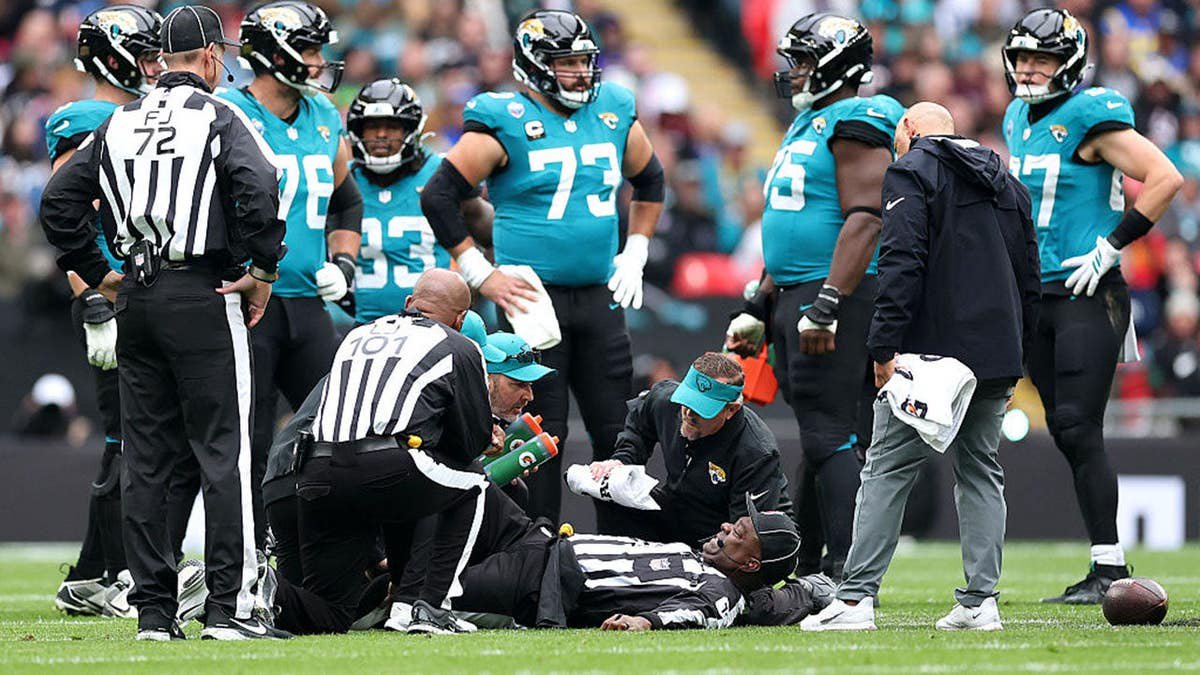 Umpire Larry Smith receives medical attention at Wembley Stadium.