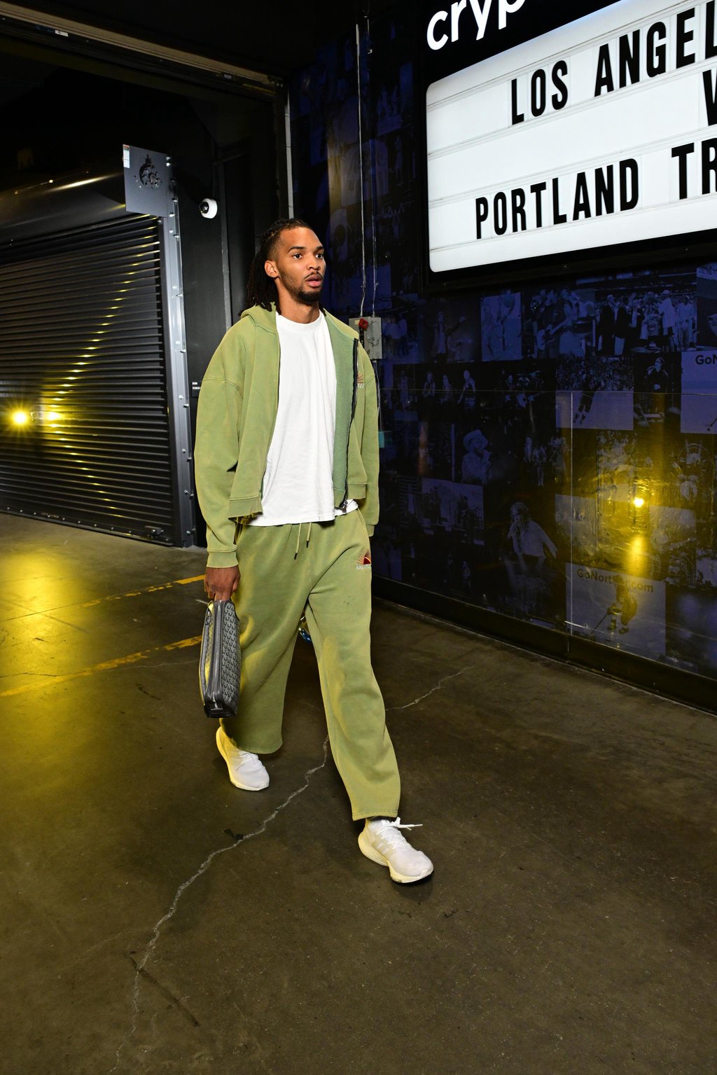 Ziaire Williams of the Los Angeles Lakers arrives at Crypto.com Arena wearing a green tracksuit.
