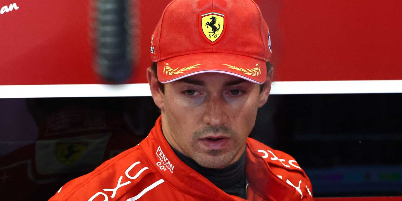 Charles Leclerc looks on in the Ferrari garage