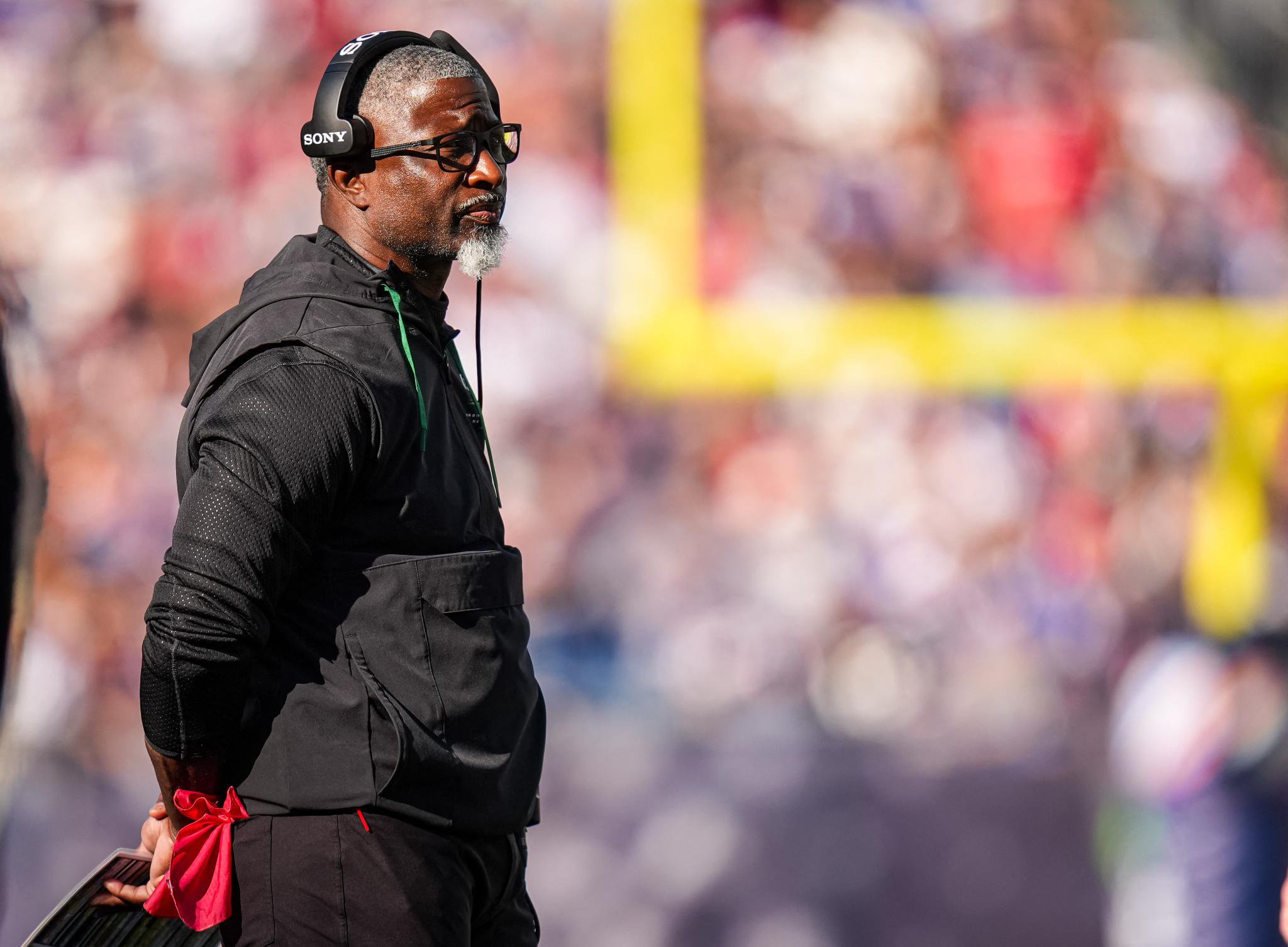 New York Jets head coach Aaron Glenn watches from the sideline during a game against the New England Patriots.