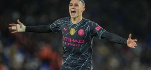 Man City beats Brighton 4-0 to stay on course for another Premier League title. Phil Foden scores 2