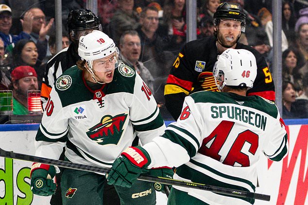 Minnesota Wild's Bobby Brink (10) celebrates with Jared Sturgeon (46) after scoring a goal during the second period of an NHL hockey game, in Vancouver, British Columbia, Sunday, Oct. 25, 2026. (Jacob Mallari/The Canadian Press via AP)