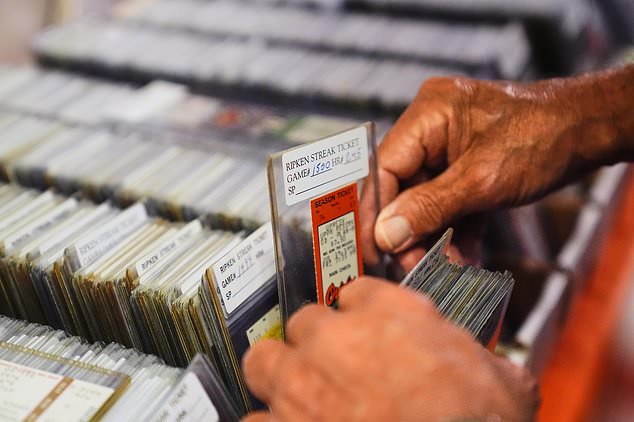 Baltimore Orioles fan Rick Taylor thumbs through his collection of tickets from almost every baseball game of Cal Ripken Jr.'s 2,632 game "Iron Man" streak, at his home in Reisterstown, Md., Tuesday, Oct. 13, 2026. (AP Photo/Stephanie Scarbrough)