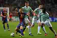 Charlie Mulgrew and Victor Wanyama of Celtic challenge Andres Iniesta of Barcelona during the UEFA Champions League Group G match between Celtic an...