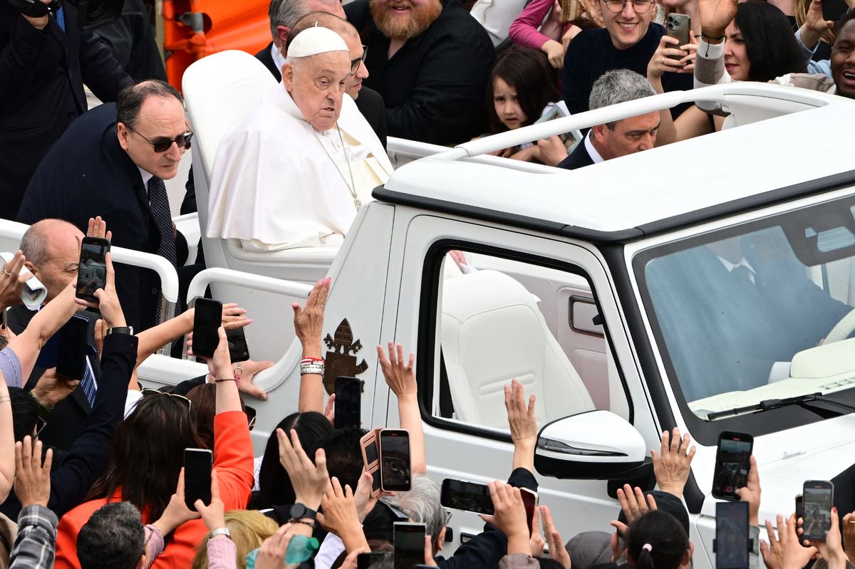 Pope Francis waves to the crowd from the popemobile