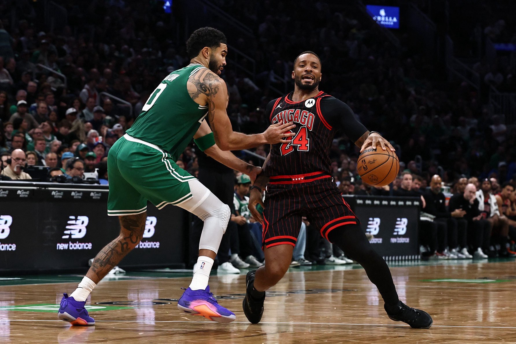 Oct 26, 2026; Boston, Massachusetts, USA; Boston Celtics forward Jayson Tatum (0) tries to slow down Chicago Bulls guard Norman Powell (24) during the second quarter at TD Garden. Mandatory Credit: Winslow Townson-Imagn Images