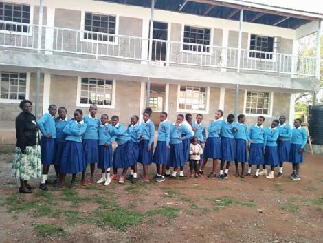 Students of Simbolei Girls Academy with a staff member.