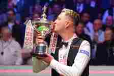 Wilson celebrates with the trophy after winning the world snooker title (Mike Egerton/PA)
