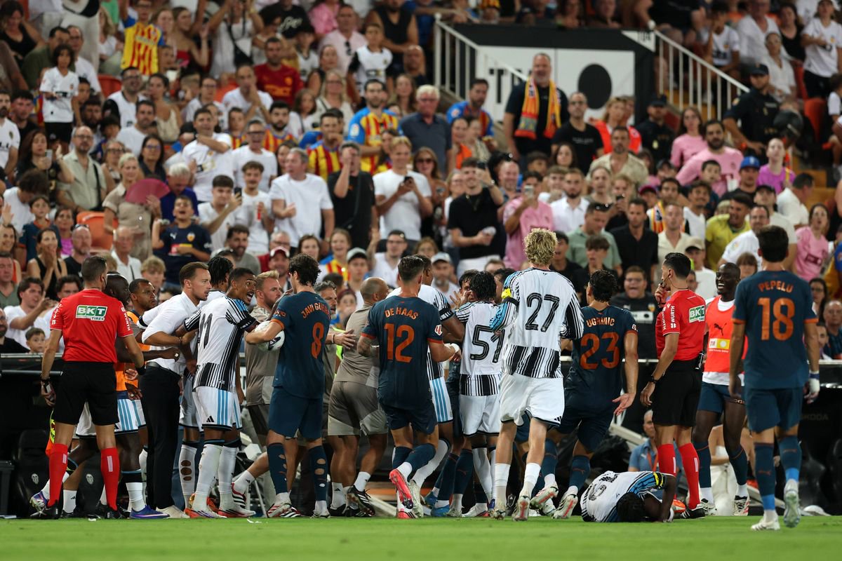 Players of Newcastle United clash with players of Valencia after Anthony Elanga's injury