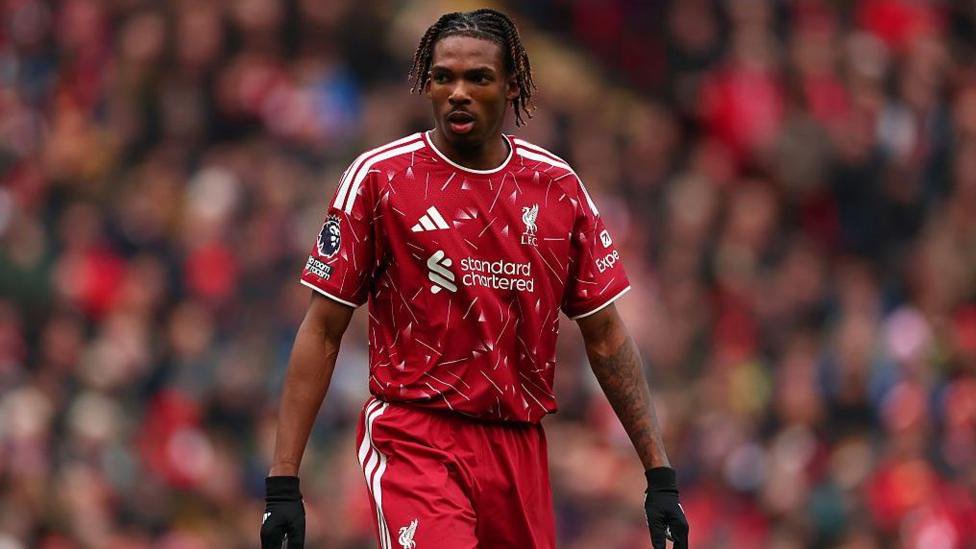 Jeremy Jacquet in Liverpool kit with a blurred crowd behind him