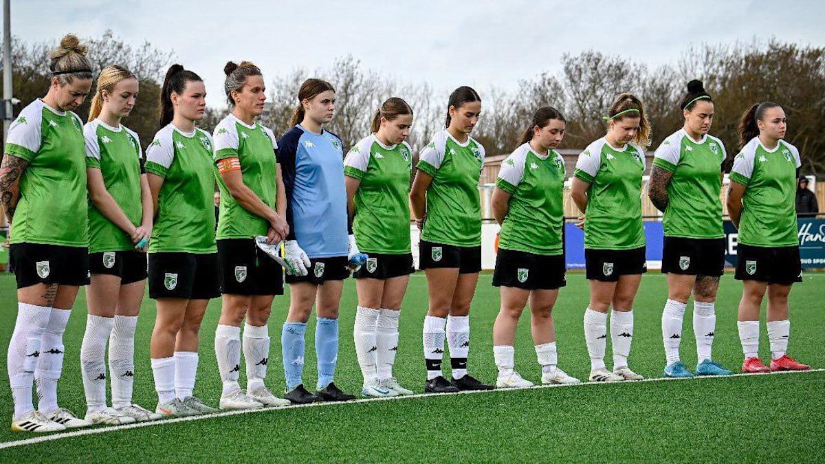 Guernsey FC Women line up on the centre circle before a game.