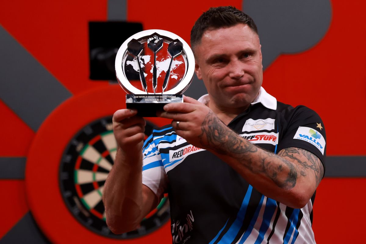 Gerwyn Price of Wales poses with the runners-up trophy after defeat against Ross Smith of England in their Final match during the 2026 World Series of Darts Finals