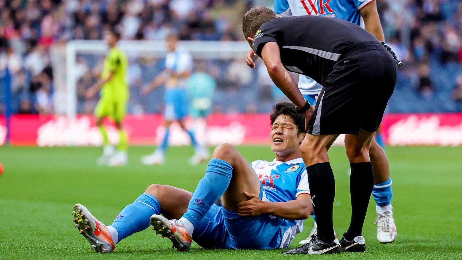 Yuki Ohashi lies injured during a game for Blackburn Rovers earlier this season