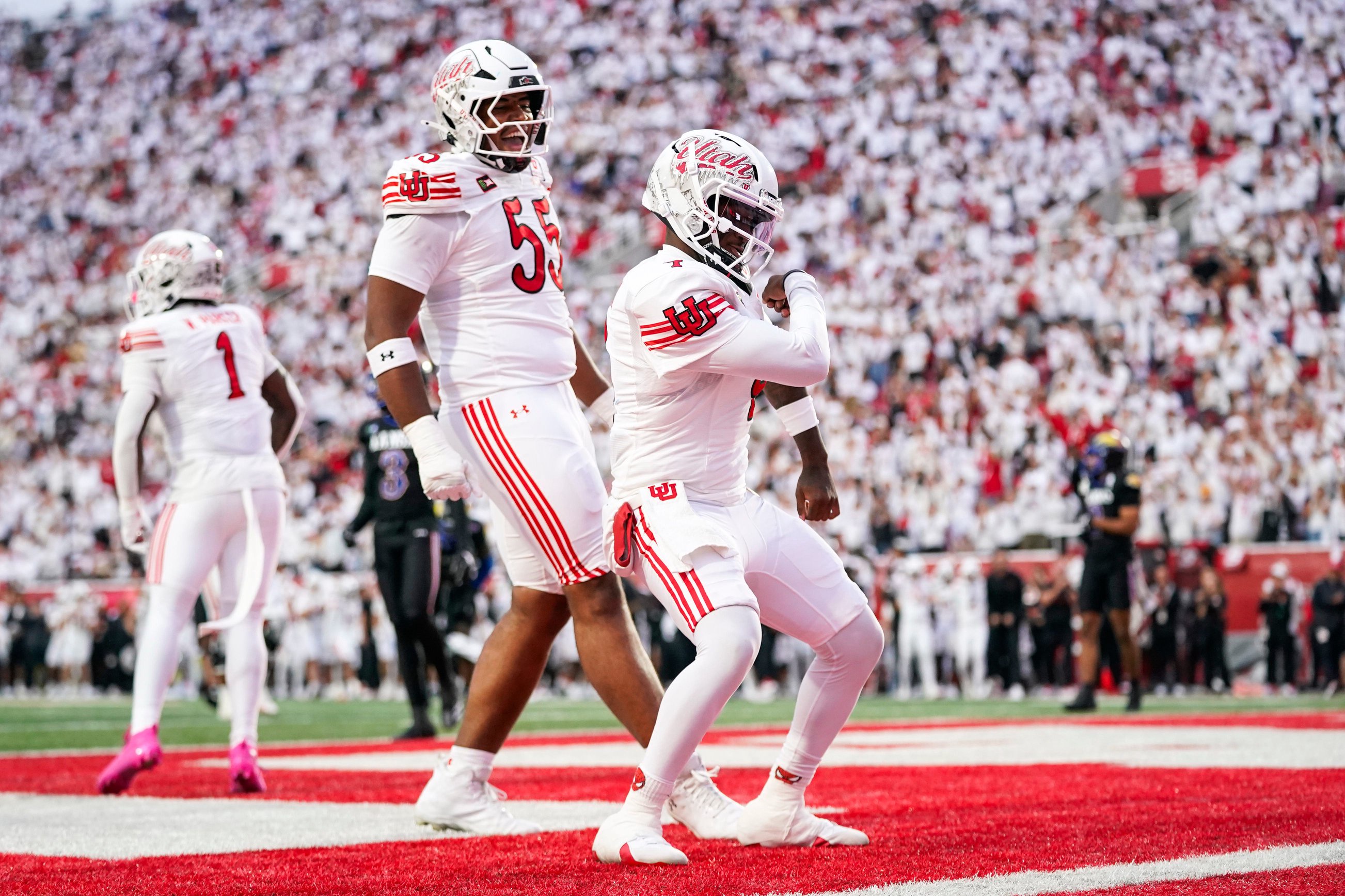 Oct 10, 2026; Salt Lake City, Utah, USA; Utah Utes quarterback Devon Dampier (4) dances after scoring a first half touchdown with offensive lineman Kelvin Obot (55) against the Kansas Jayhawks at Rice-Eccles Stadium. Mandatory Credit: Aaron Baker-Imagn Images