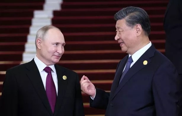 Russia's President Vladimir Putin and Chinese President Xi Jinping interacting during a welcoming ceremony at the Third Belt and Road Forum in Beijing