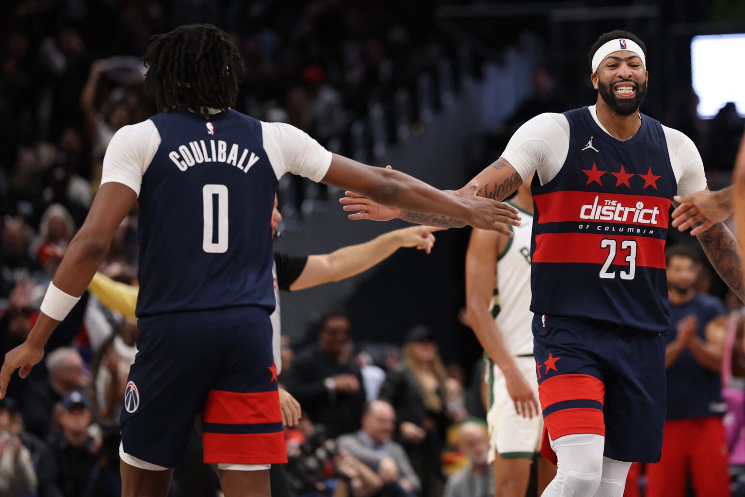 Oct 21, 2026; Washington, District of Columbia, USA; Washington Wizards forward Anthony Davis (23) celebrates with Wizards guard Bilal Coulibaly (0) during a stoppage in play against the Milwaukee Bucks in the fourth quarter at Capital One Arena. Mandatory Credit: Geoff Burke-Imagn Images