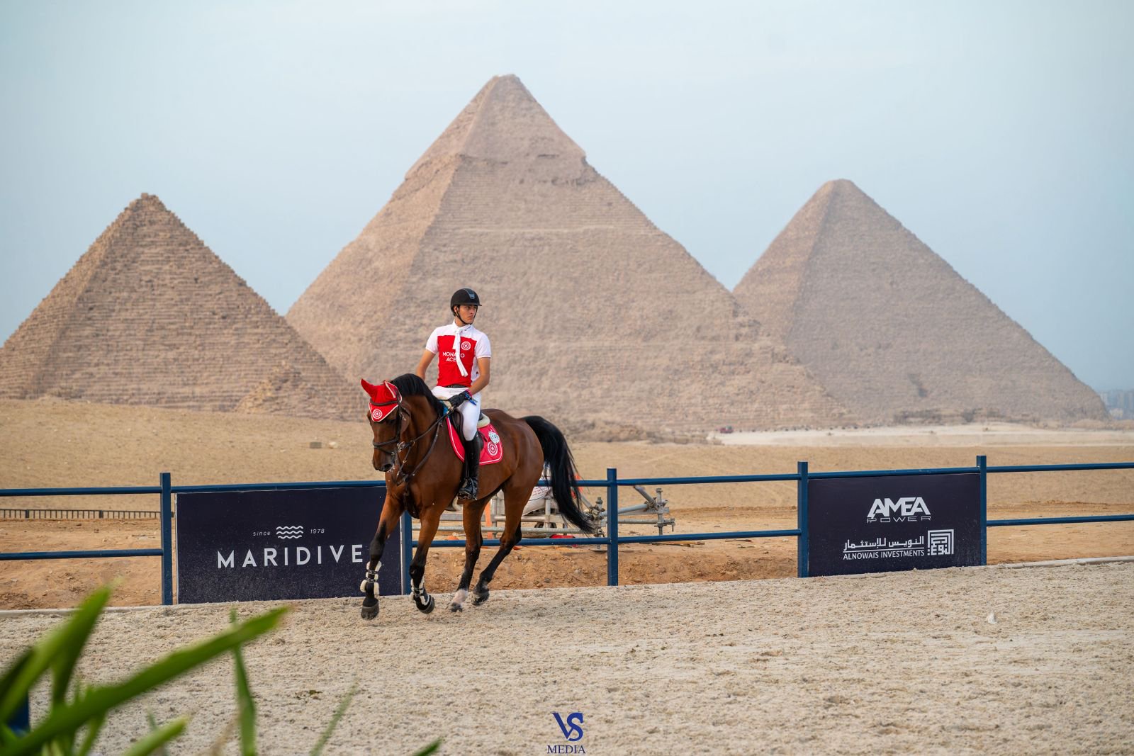 Inigo Lopez De La Osa Franco rides in the Monaco Aces colors at the Longines Global Champions Tour of Cairo, with the Pyramids of Giza behind the arena. (Supplied)