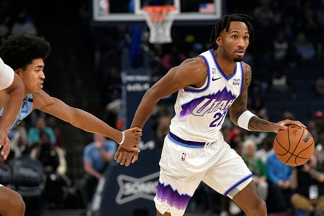 Utah Jazz guard Darryn Peterson (22) handles the ball ahead of Memphis Grizzlies forward Jaylen Wells in the first half of an NBA basketball game Wednesday, Oct. 21, 2026, in Memphis, Tenn. (AP Photo/Brandon Dill)