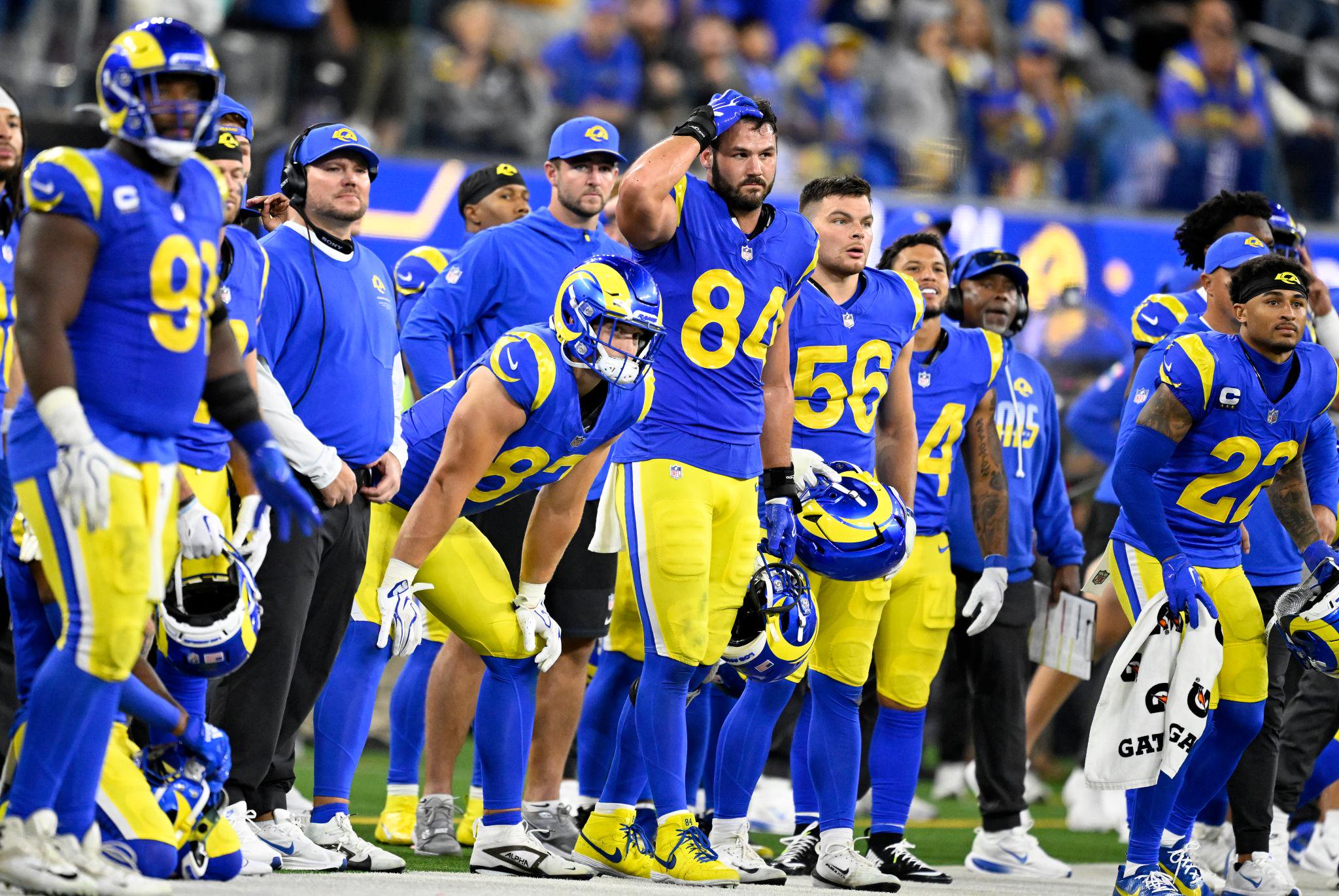 Los Angeles Rams players and coaches watch from the sideline during a game against the Buffalo Bills at SoFi Stadium.