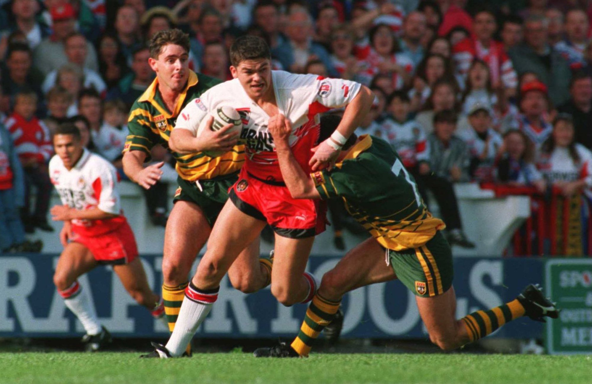 Wigan's Andy Farrell attempts to run past Australia's Ricky Stuart during a 1994 tour match in Wigan