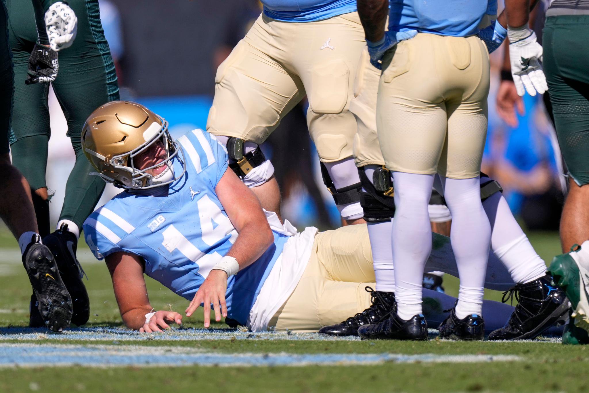 Ty Dieffenbach lying on the field after getting tackled during a game.