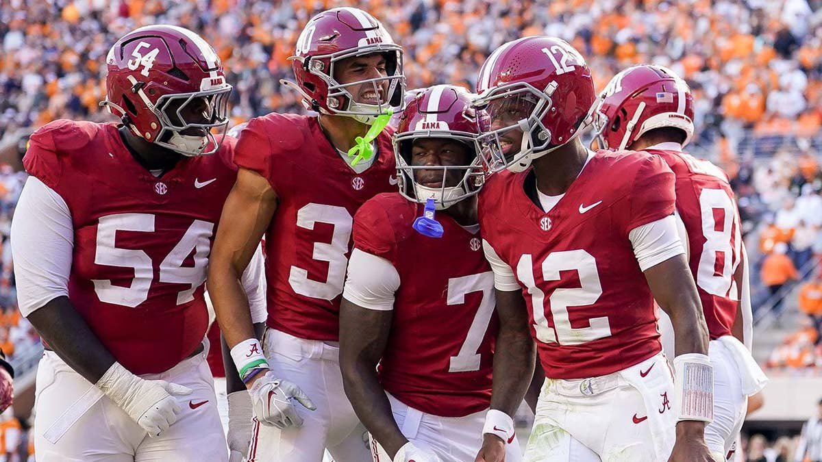 Alabama football players celebrating a touchdown at Neyland Stadium