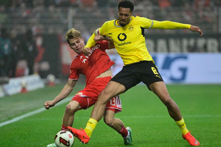 Dortmund's Nmecha battles for the ball