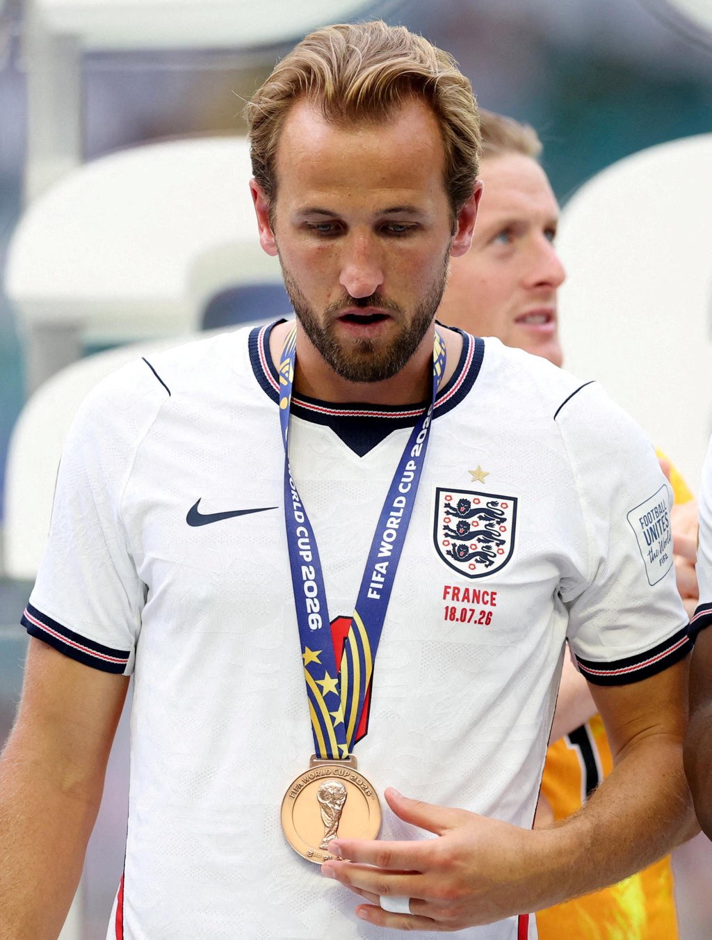 England's Harry Kane stands on the podium during the World Cup medal ceremony.