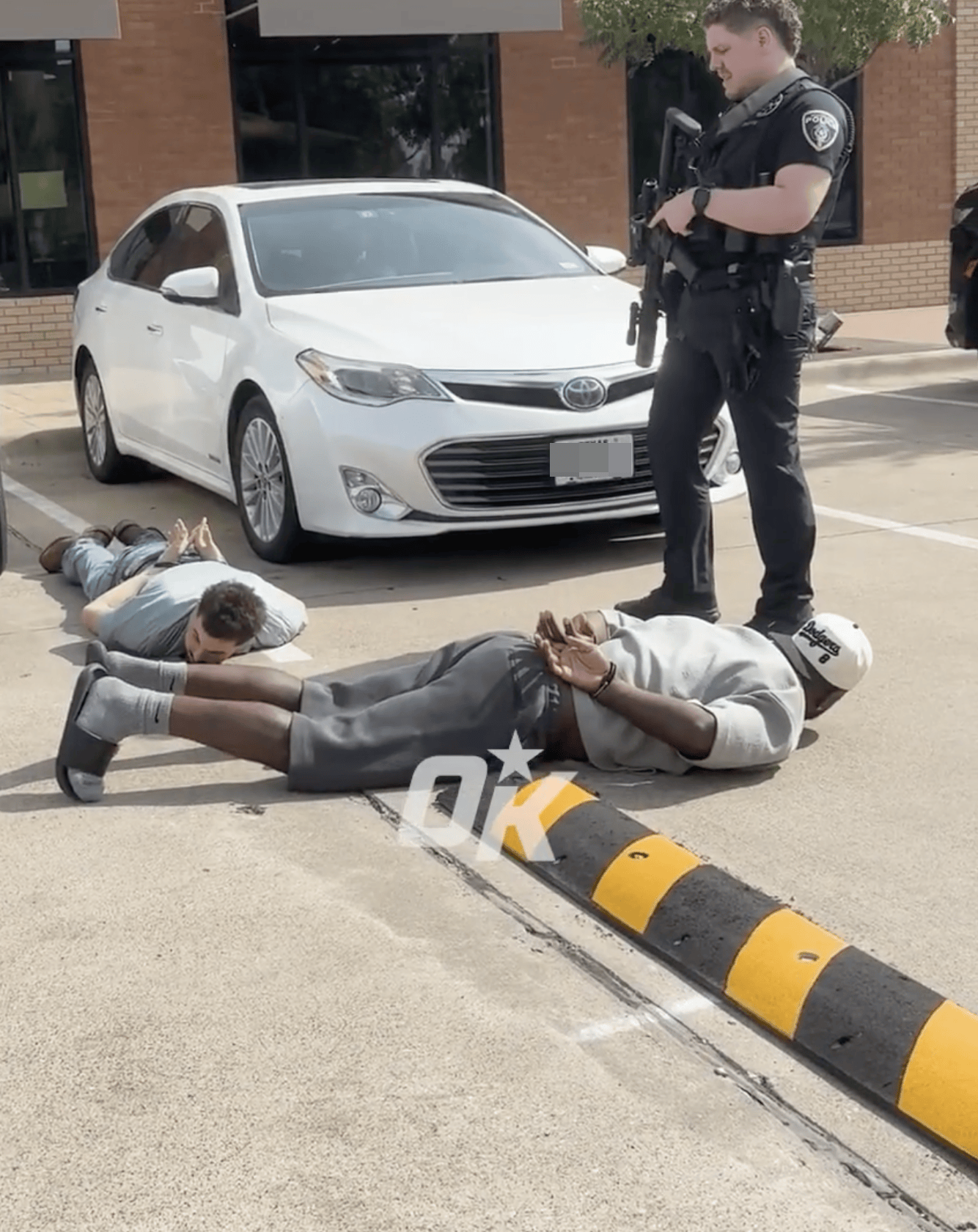 Dez Bryant handcuffed and held at gunpoint on the ground by police.